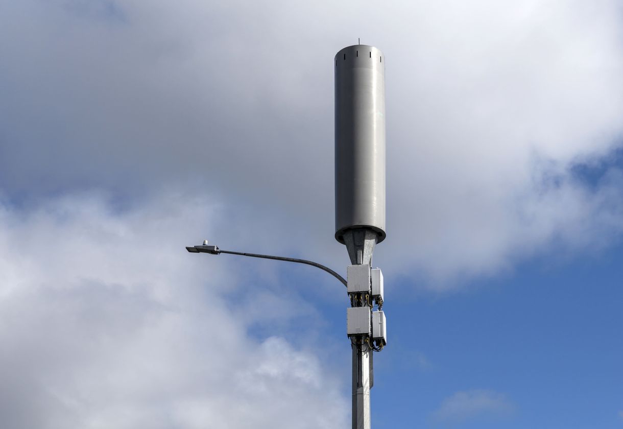 Small cell towers with antennas in city area.